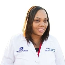 headshot of nurse practitioner Urline Gregoire, a Black woman with shoulder-length black hair and a white lab coat