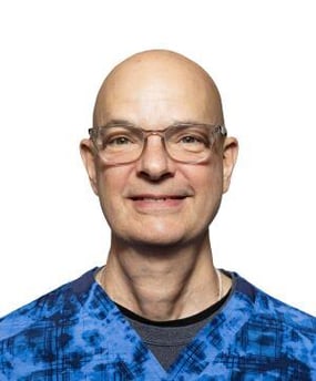 headshot from shoulders up of bald white man with glasses
