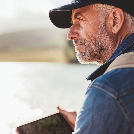Side profile (close up) of older man sitting outside